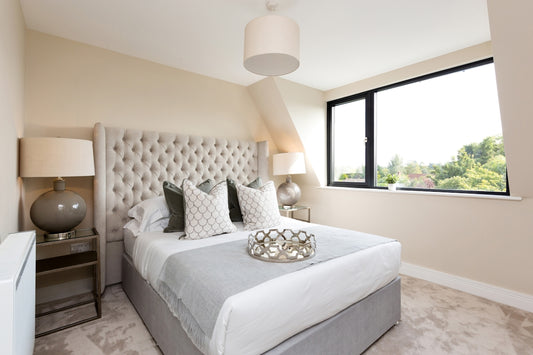 a bedroom with a large bed and a large window