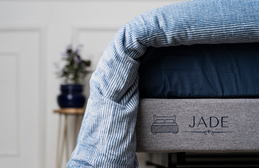 a close up of a bed with a name on it