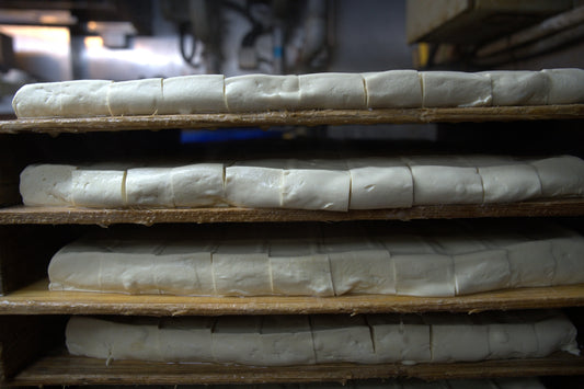 a bunch of bread that are on a shelf