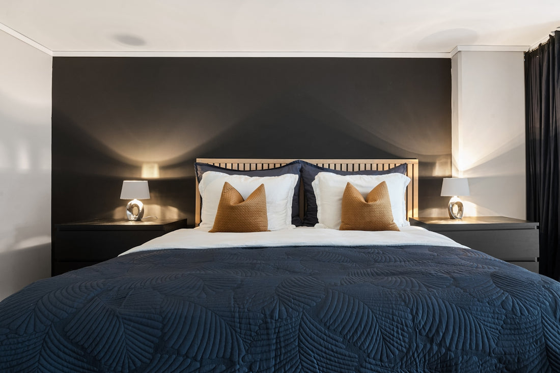 A bedroom with a large bed and two night stands