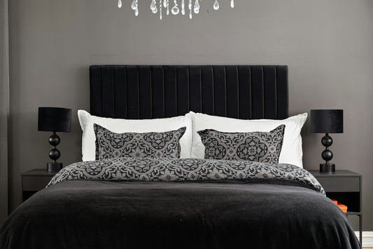 A black and white bedroom with a chandelier