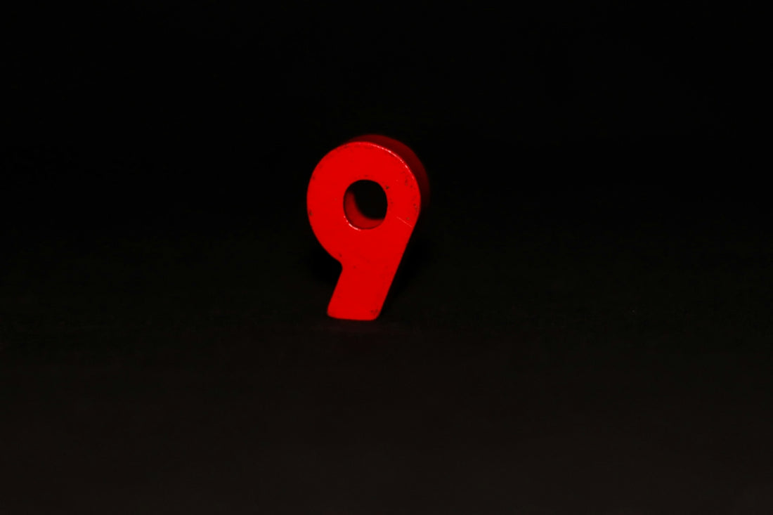 A red sign that is on the side of a building