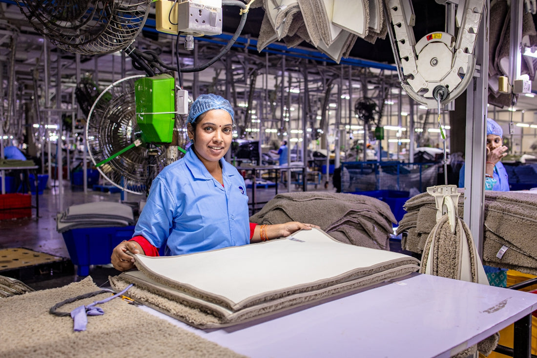Woman folding textiles in an industrial laundry.