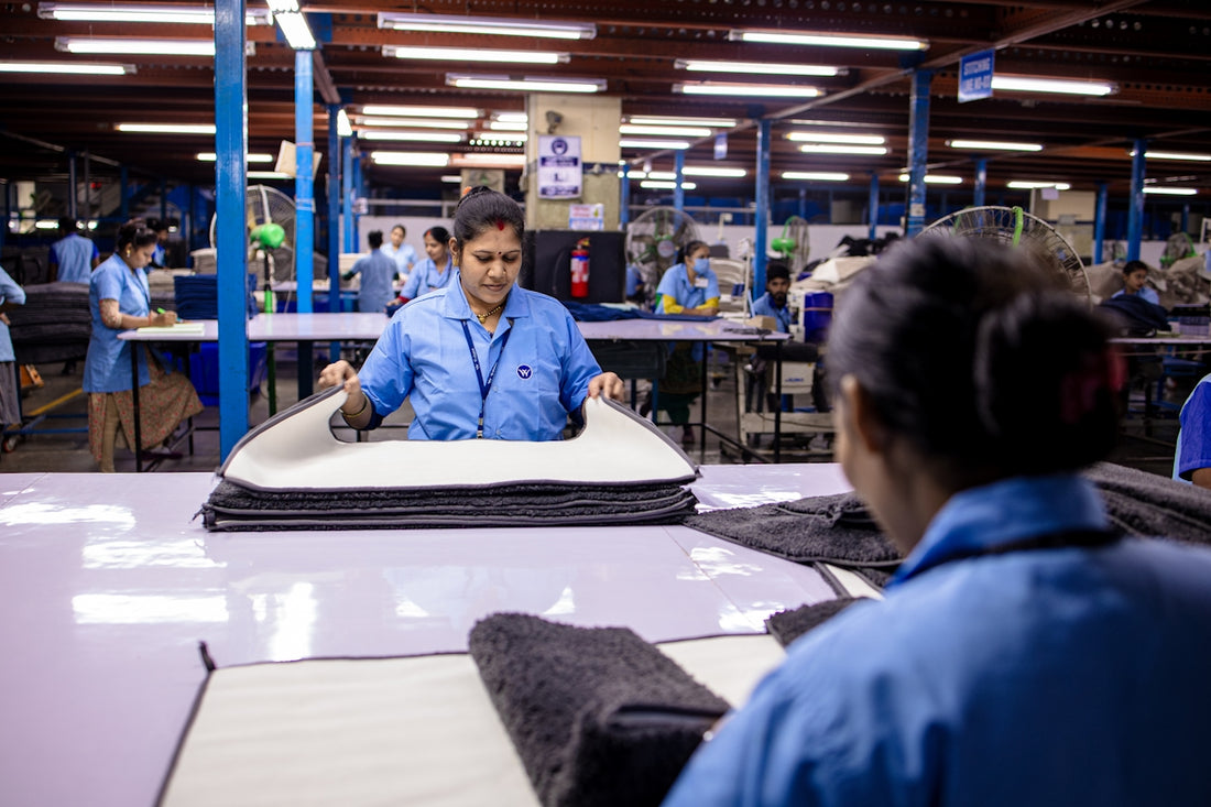 Workers are busy assembling materials in a factory.