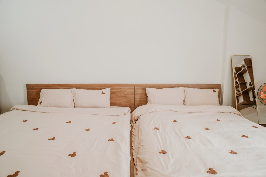 Two beds with matching bedding are present.