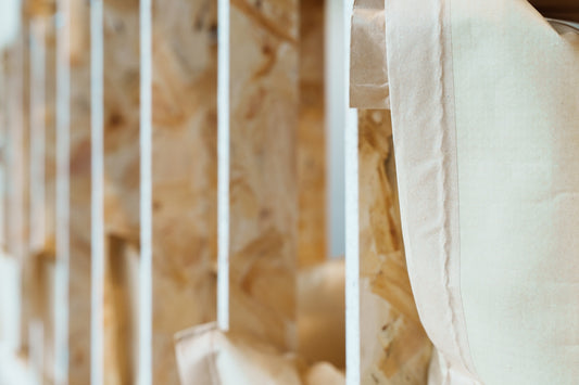 Fabric hangs between wooden beams, a close-up shot.