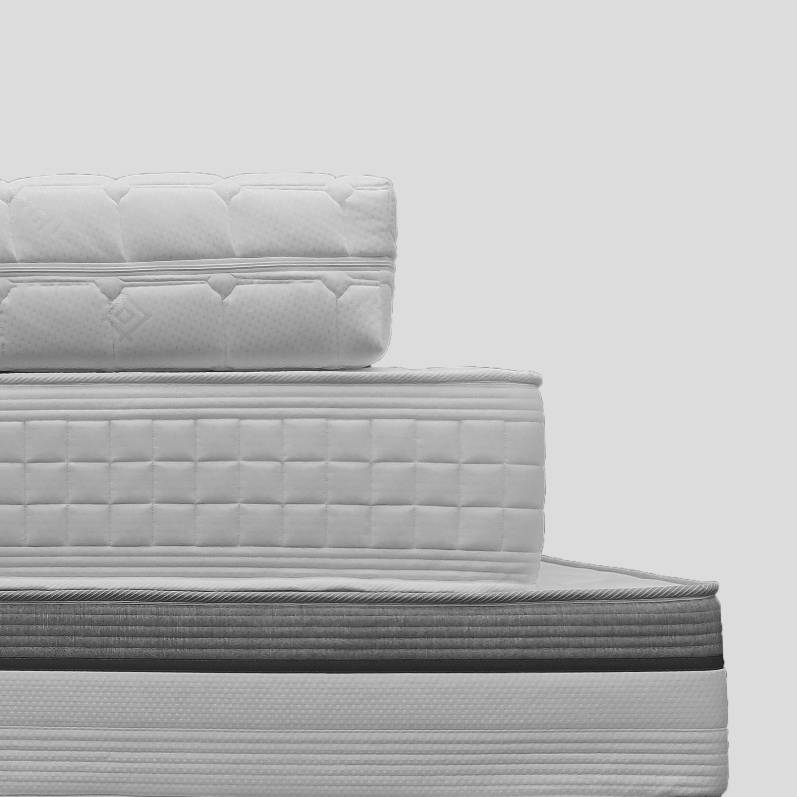 Stack of various made-to-measure mattresses neatly arranged, highlighting the diverse range of custom options available.
