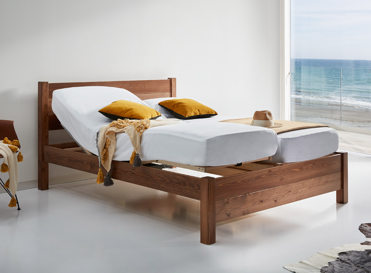 Adjustable wooden bed frame by Get Laid Beds, featuring two mattresses laid on separate beds, highlighting the customizable comfort and modularity of the sleep system.