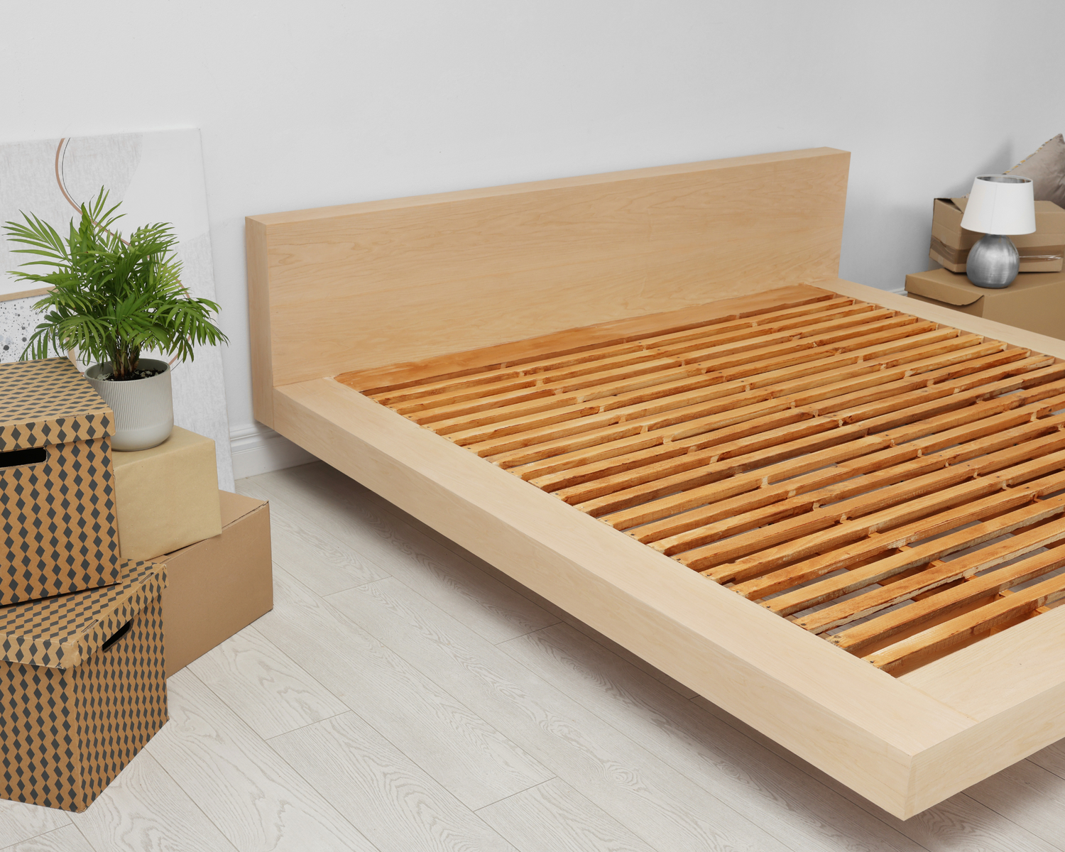 A bed frame showing its strong base support of solid wooden slats to support its mattress.