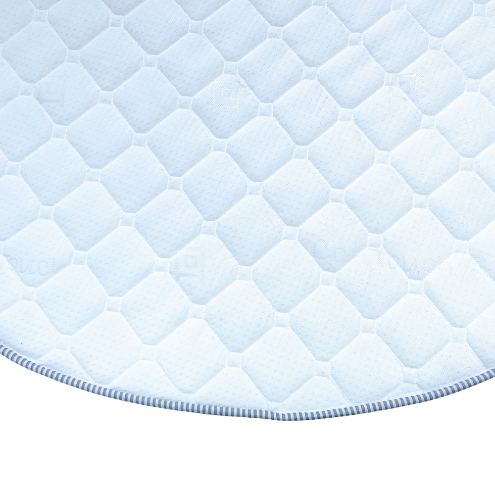 Image showcasing the foot end of an island bed mattress, highlighting the precision and elegant curve of the cut, demonstrating the mattress's finished quality.