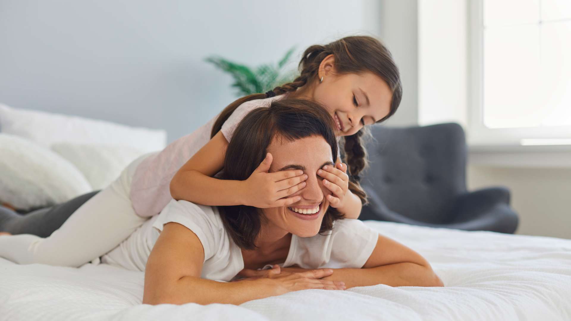 Mother and child enjoy playful bonding on a supportive, custom-shaped hybrid pocket memory mattress.