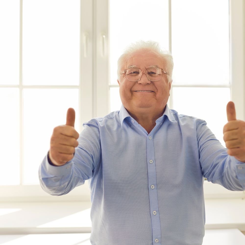 Man with thumbs up celebrates finding the perfect custom mattress with MyBespokeMattress's help