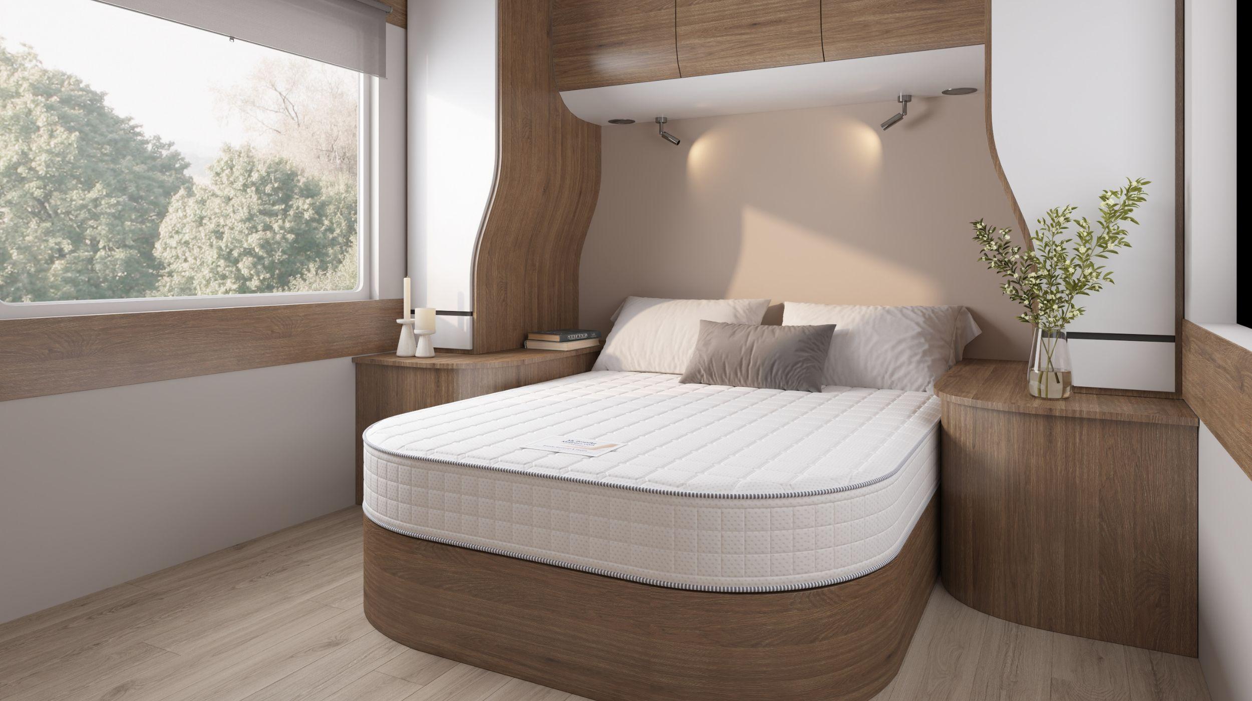 Custom-shaped island bed mattress showcased within a spacious and modern caravan.