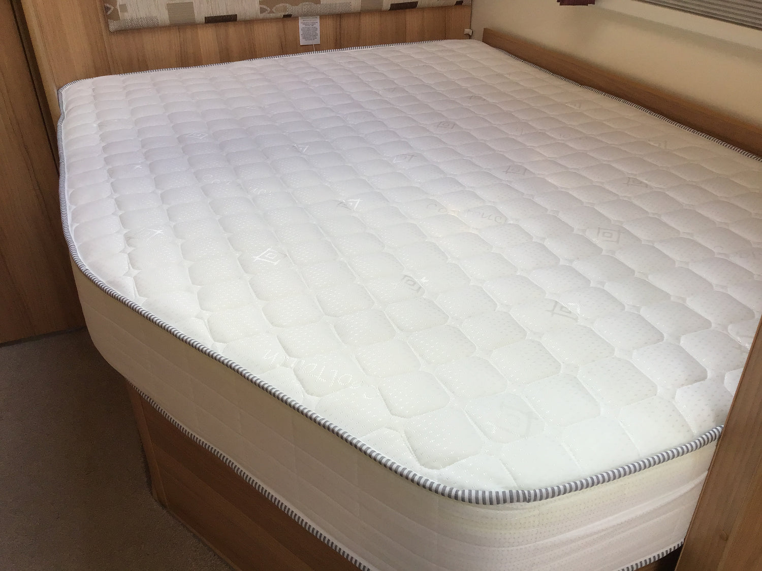 Full-size, made-to-measure memory foam mattress perfectly fitted on a bed base, showcasing its custom dimensions and comfort.