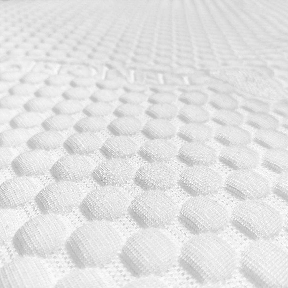 Close-up of "bubble" fabric on a caravan mattress topper, showcasing its soft, textured surface.