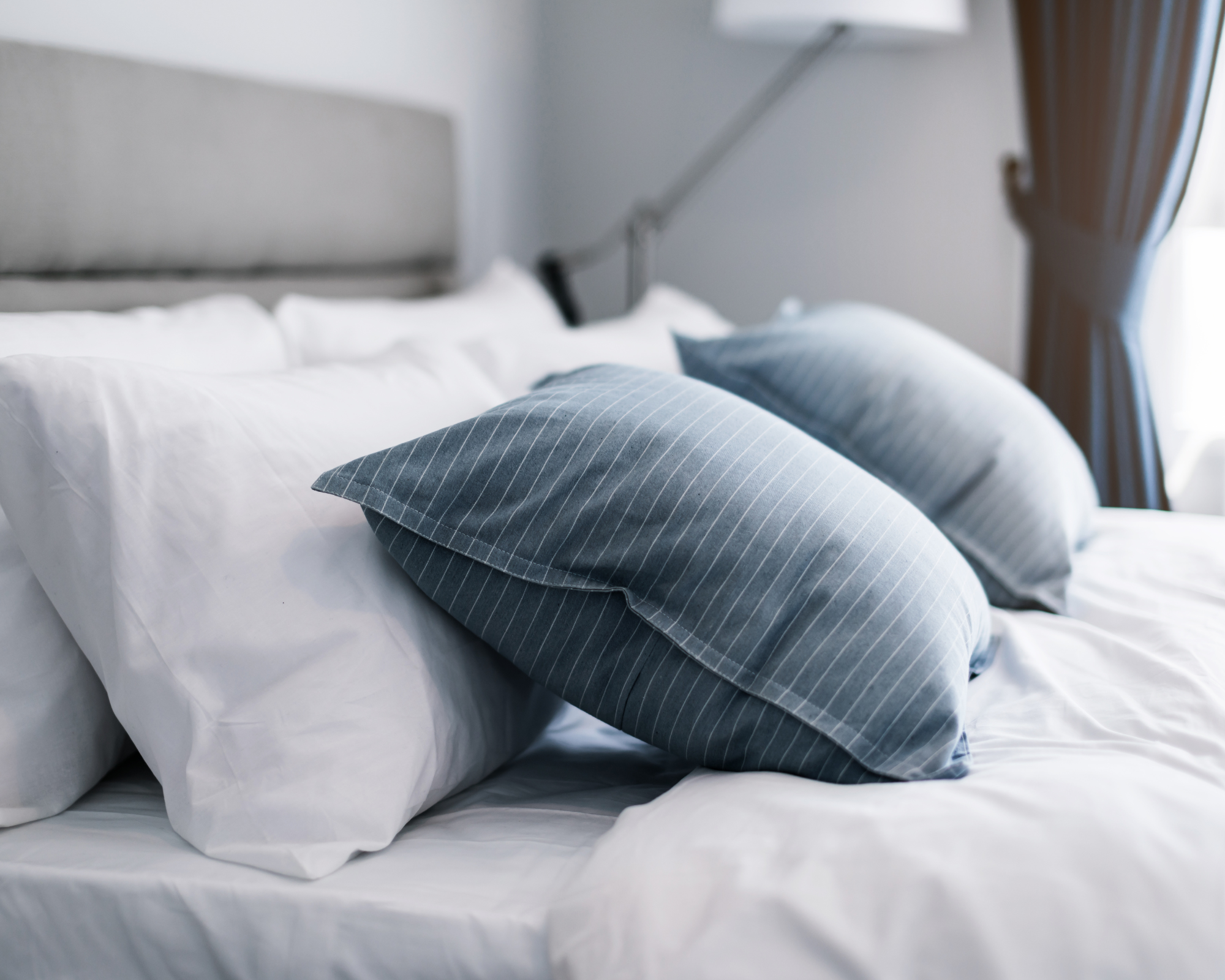 Assorted sheets and bedding neatly displayed, showcasing a variety of textures and colors for a cosy sleep environment.